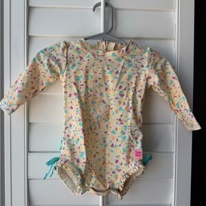 RuffleButts Confetti Beach One Piece Rash Guard Swimsuit - 6-12m